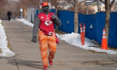 The self-dubbed ChiefsAholic walks toward the Denver Broncos stadium before an NFL game on January 8