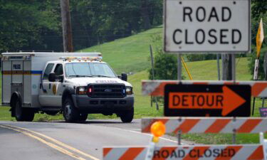 A roadblock is seen as crews search for a a pair of missing children swept away after weekend rains