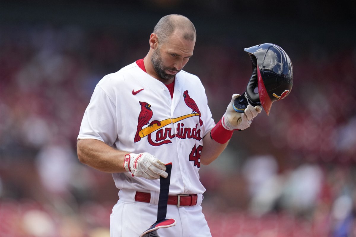 St. Louis Cardinals' Paul Goldschmidt removes his hemet after flying out with the bases loaded to end the eighth inning of a baseball game against the Colorado Rockies Sunday, Aug. 6, 2023, in St. Louis. 