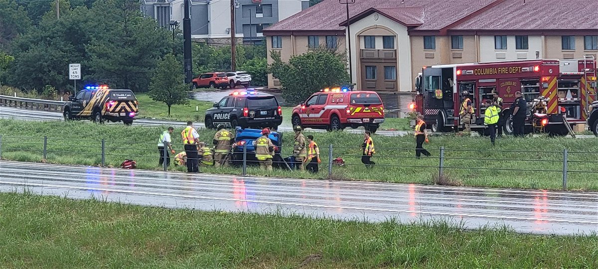 Emergency workers remove a person from a vehicle on Highway 63 in Columbia on Tuesday, Aug. 1, 2023.