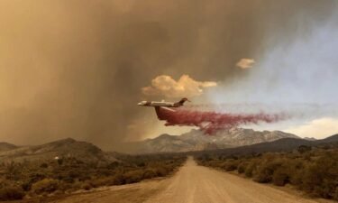 A tanker makes a fire retardant drop over the York Fire in Mojave National Preserve on Saturday.