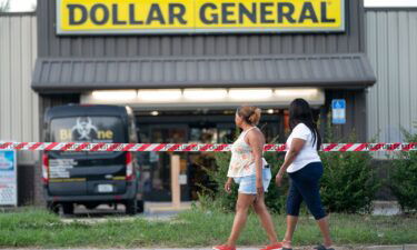 People walk past the Dollar General store Sunday in Jacksonville