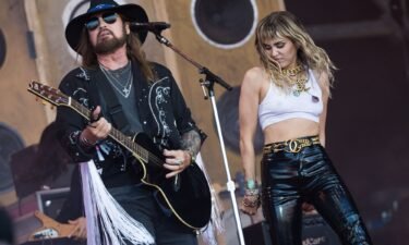 Billy Ray Cyrus and Miley Cyrus perform together in 2019.