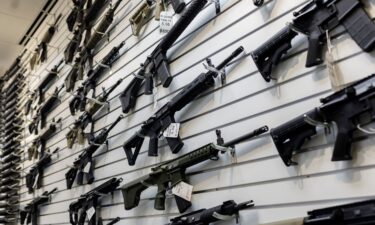 A selection of AR-15-style rifles hangs on a wall at a firearms store on January 11 in Carpentersville