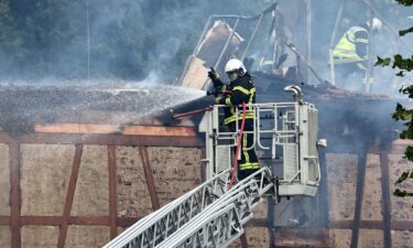 A firefighter sprays water after a fire erupted at a home for disabled people in Wintzenheim near Colmar