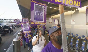 Workers with SEIU Local 721 join a picket line at the Los Angeles International Airport.