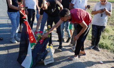 Palestinians gather at the scene where Israeli forces targeted a Palestinian car