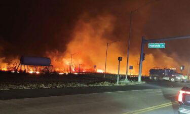 Flames are seen at the intersection of Hokiokio Place and Lahaina Bypass in Maui