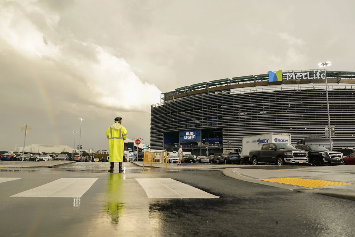 A parking attendant views a rainbow outside Met Life stadium before an NFL football game between the New York Jets and the Buffalo Bills, Monday, Sept. 11, 2023, in East Rutherford, New Jersey.