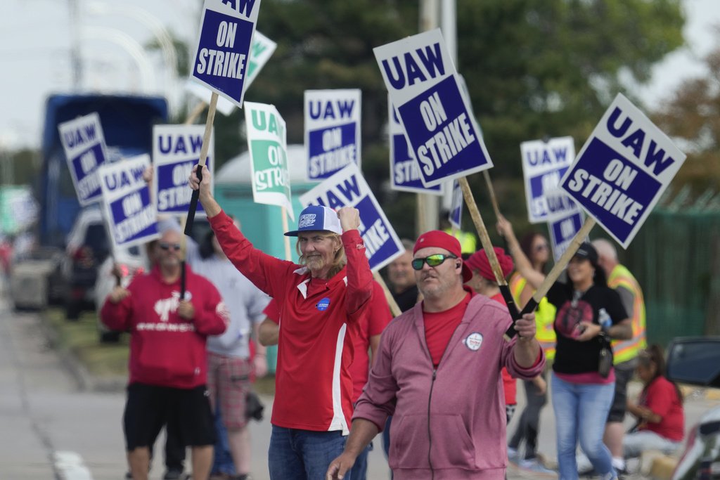 FILE - United Auto Workers members walk a picket line during a strike at the Ford Motor Company Michigan Assembly Plant in Wayne, Mich., Friday, Sept. 15, 2023. 