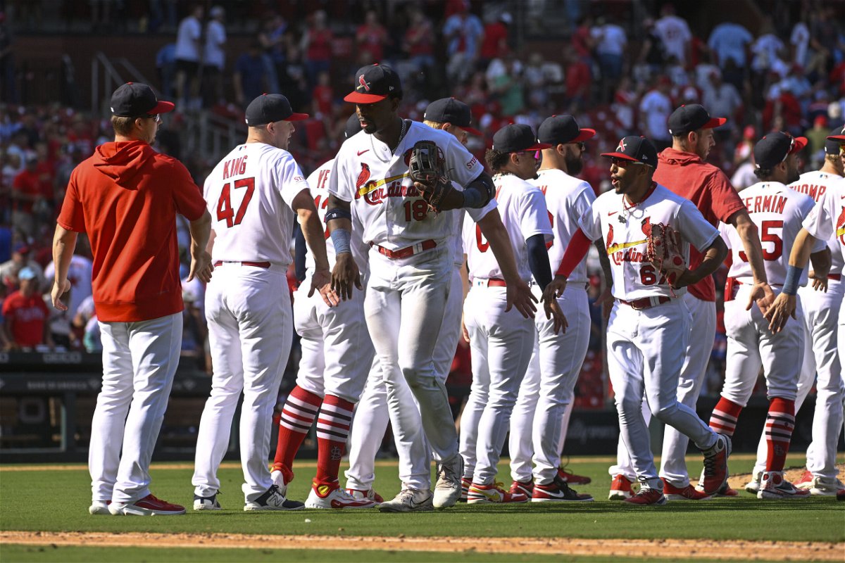 Members of the St. Louis Cardinals celebrate their team's 6-5 victory after a baseball game against the Philadelphia Phillies, Sunday, Sept. 17, 2023, in St. Louis. 