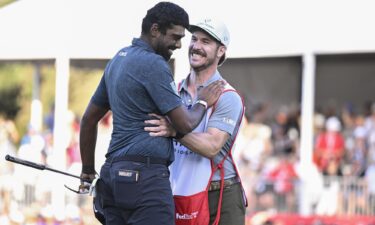 Theegala is congratulated by caddie Carl Smith.