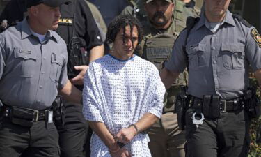 Officers escort Danilo Cavalcante from a Pennsylvania State Police barracks in Avondale on September 13.