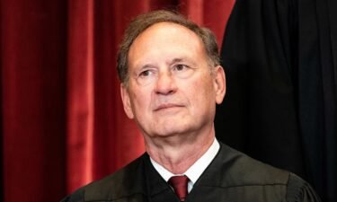 Associate Justice Samuel Alito sits during a group photo of the Justices at the Supreme Court in Washington
