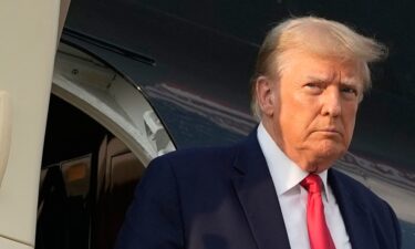 Former President Donald Trump steps off his plane as he arrives at Hartsfield-Jackson Atlanta International Airport on Thursday