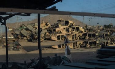 Destroyed Humvees used during the war against the Taliban are seen stacked to be sold as scrap metal in Kandahar City