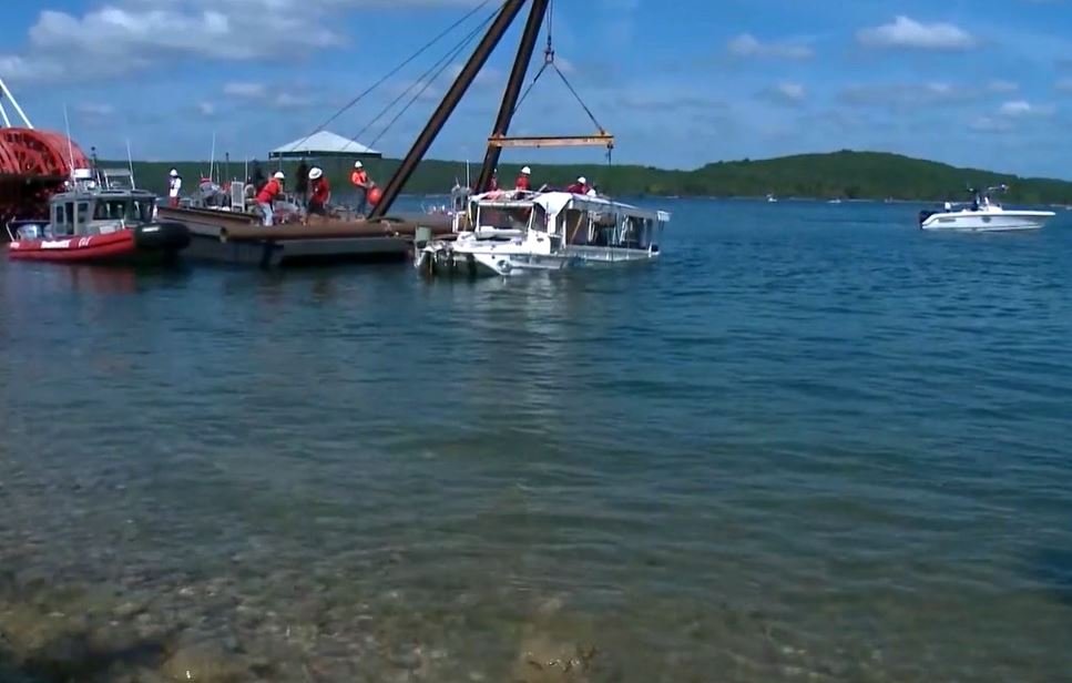 FILE - A duck boat is pulled out of Table Rock Lake after it sank in a storm, killing several of those on board.