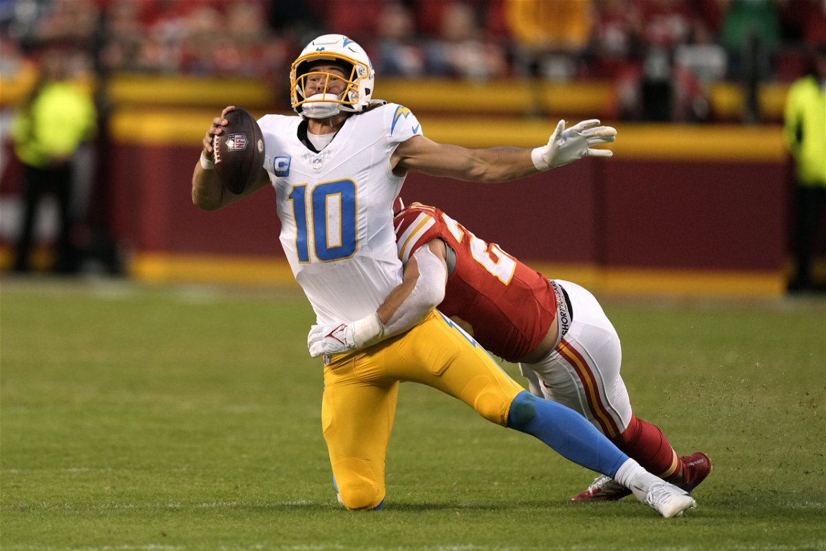 Los Angeles Chargers quarterback Justin Herbert (10) is sacked by Kansas City Chiefs linebacker Drue Tranquill during the second half of an NFL football game Sunday, Oct. 22, 2023, in Kansas City, Mo. 
