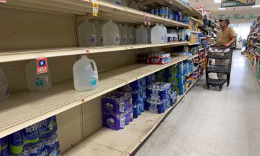 Mostly empty shelves of bottled water at Fremin's Food Market in Port Sulphur