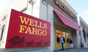 Customers use ATMs at a Wells Fargo Bank on April 14 in San Bruno