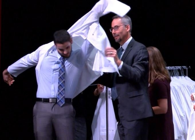 FILE - A new doctor gets his white coat during a ceremony at the University of Missouri.
