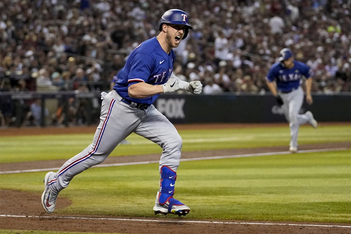 Texas Rangers' Mitch Garver celebrates after a RBI single against the Arizona Diamondbacks during the seventh inning in Game 5 of the baseball World Series Wednesday, Nov. 1, 2023, in Phoenix. 