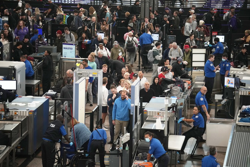 Travellers queue up to pass through the south security checkpoint at Denver International Airport, Monday, Nov. 20, 2023, in Denver. Despite inflation and memories of past holiday travel meltdowns, millions of people are expected to hit airports and highways in record numbers over the Thanksgiving Day break.