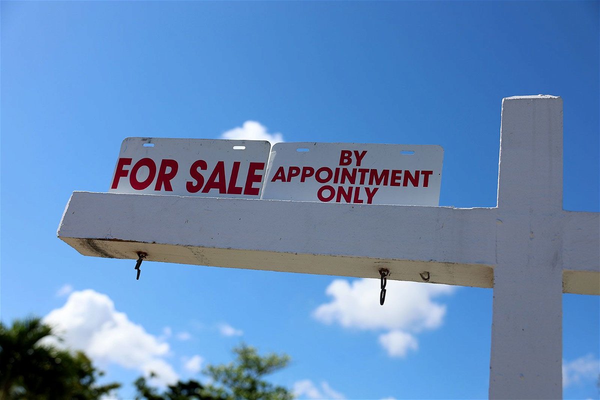 A For Sale sign displayed in front of a home on February 22, in Miami.
