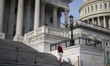 Rep. George Santos walks back to his office after debate on the House floor on a resolution to expel him from Congress