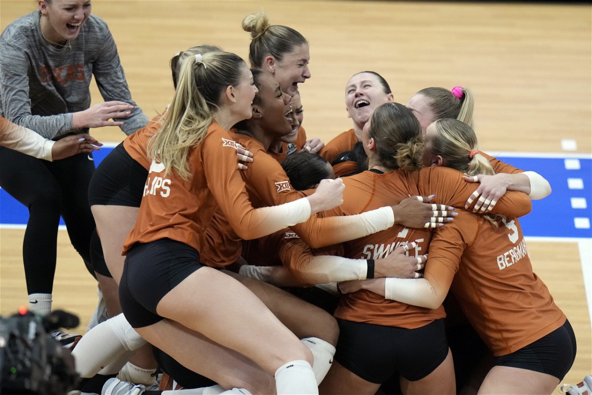 Texas players celebrate after winning the NCAA Division I women's college volleyball tournament against Nebraska Sunday, Dec. 17, 2023, in Tampa, Fla. 