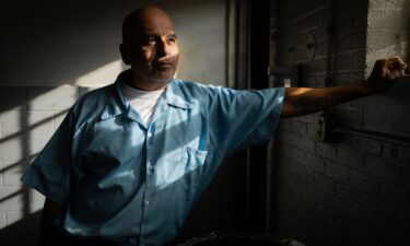 James Soto adjusts his regalia during a November graduation ceremony for students of the Northwestern Prison Education Program at Stateville Correctional Center in Crest Hill