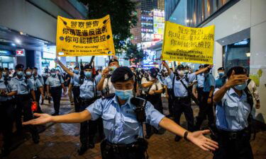 Police lead Hong Kong pro-democracy publisher Jimmy Lai away from his home after he was arrested under the national security law on August 10