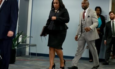 Fulton County District Attorney Fani Willis arrives to speak at a news conference at the Fulton County Government building on August 14