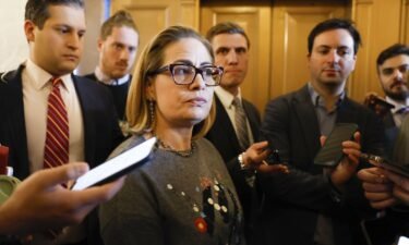 Kyrsten Sinema dismisses Senate reelection questions amid slowed fundraising and seen here speaks to reporters during a vote in the Senate Chambers on January 25.
