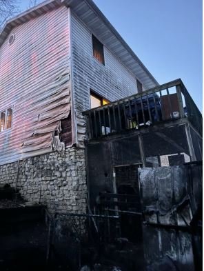 Melted siding is visible on a home where a shed burned on Independence Drive in Jefferson City on Tuesday, Jan. 16, 2024.