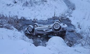 Roadside hero rescues teen brothers from upside down car in water-filled ditch.