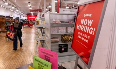 A 'now hiring' sign is displayed in a retail store in Manhattan on January 05