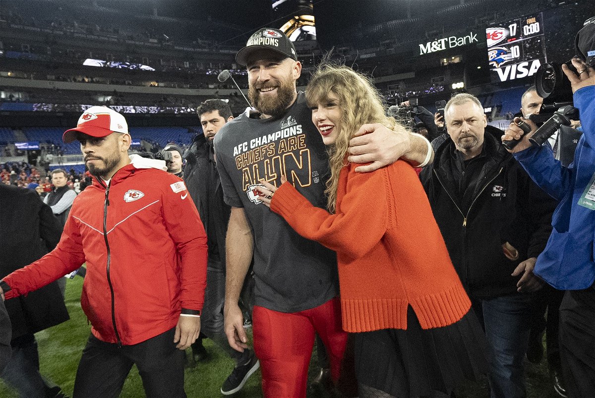 Kansas City Chiefs tight end Travis Kelce and Taylor Swift walk together after an AFC Championship NFL football game on January 28.
