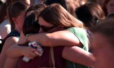 People hug at a vigil for Laken Hope Riley at the University of Georgia in Athens