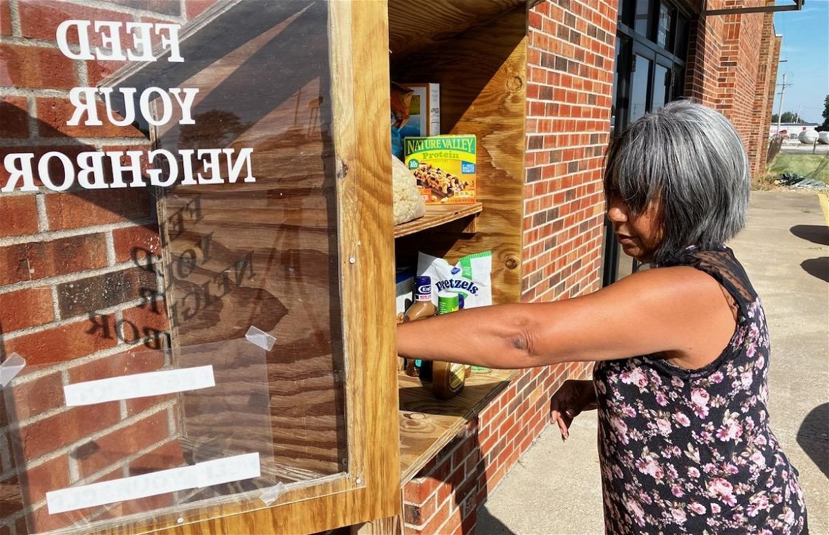 NECAC Randolph County Service Coordinator Patsy Redding stocks the agency’s Feed Your Neighbor food box in Moberly over the summer. The organization stated it would be changing the availability of the food box because of vandalism.