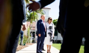 Donald and Melania Trump stand in front of members of the media after casting their votes in Palm Beach