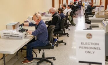 Election personnel process ballots during early voting