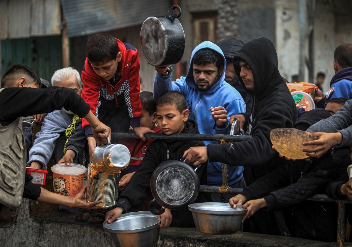 Displaced Palestinians receive food at a donation point in Rafah, southern Gaza, February 24.
