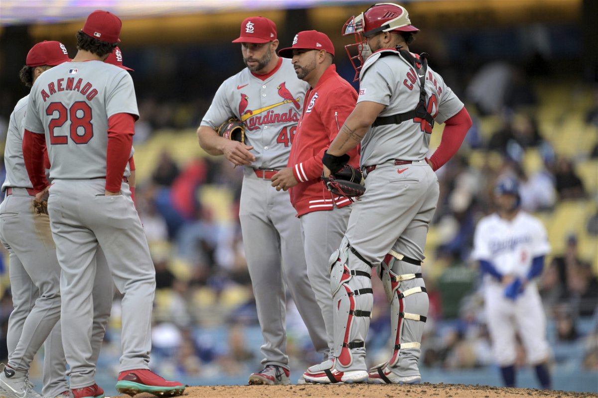St. Louis Cardinals manager Oliver Marmol, center, meets Nolan Arenado, left and Paul Goldschmidt (46) on the mound as they wait on a pitcher in the eighth inning of a baseball game against the Los Angeles Dodgers, Sunday, March 31, 2024, in Los Angeles. 