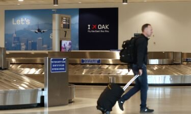 A traveler walks through baggage claim in Terminal 2 at Oakland International Airport on April 12.