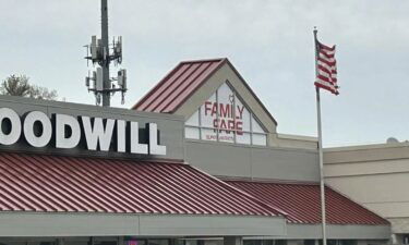 Police removed a woman from the covered sign atop the Family Fare supermarket in Midland.