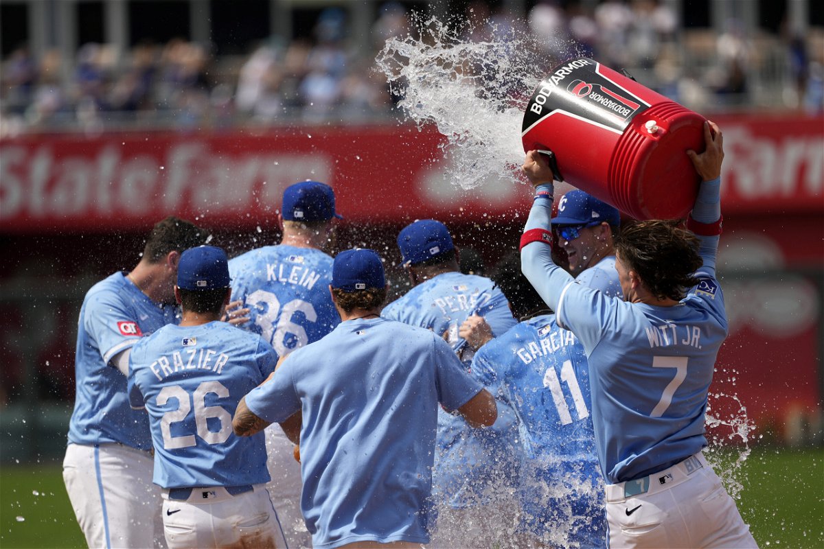 Kansas City Royals' Bobby Witt Jr. (7) douses teammates after Nick Loftin hit a sacrifice fly to score the game-winning run during the ninth inning of a baseball game against the San Diego Padres Sunday, June 2, 2024, in Kansas City, Mo. The Royals won 4-3. 