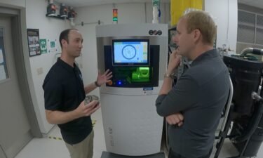 NASA engineer Tim Smith shows off a 3D printer