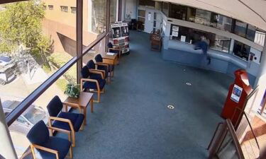 A man is seen climbing through the window of the reception area at the Pinole Public Safety Building