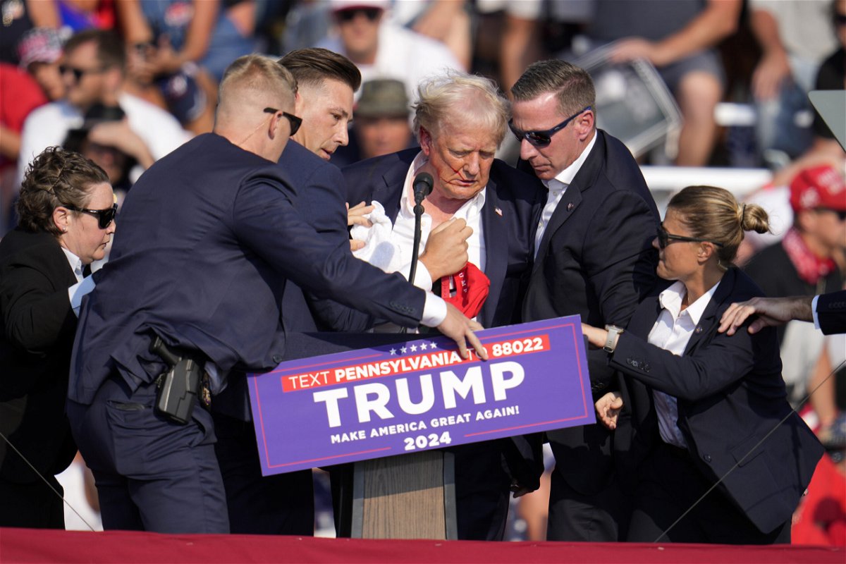 Republican presidential candidate former President Donald Trump is helped off the stage at a campaign event in Butler, Pa., Saturday, July 13, 2024.
